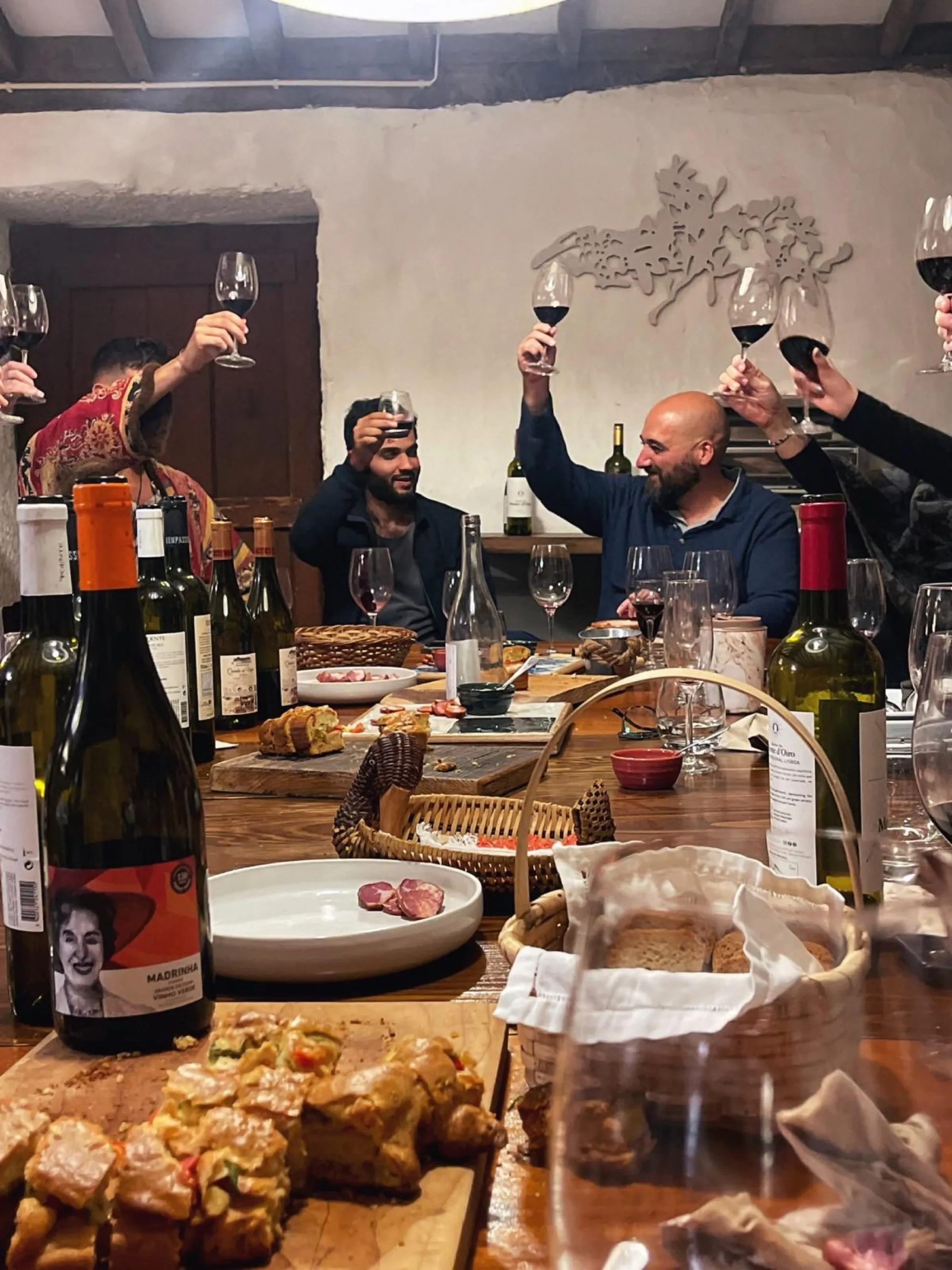 A wine tasting around the long cellar table